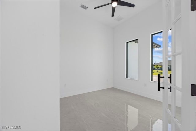 611 NW 25th Ter, Cape Coral, FL 33993 - unfurnished room featuring light marble finish floors, ceiling fan, and french doors