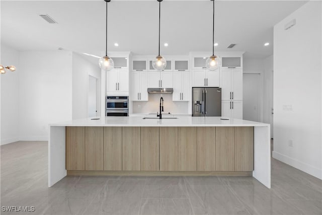 611 NW 25th Ter, Cape Coral, FL 33993 - kitchen featuring appliances with stainless steel finishes, light countertops, a large island, white cabinets, and recessed lighting