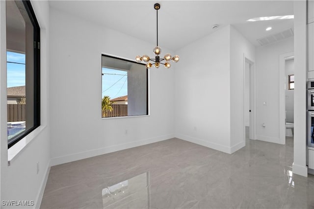 611 NW 25th Ter, Cape Coral, FL 33993 - unfurnished room with a chandelier and light marble finish flooring