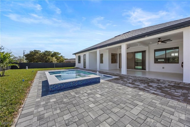 611 NW 25th Ter, Cape Coral, FL 33993 - view of swimming pool featuring a ceiling fan, a fenced backyard, a patio area, and a pool with connected hot tub