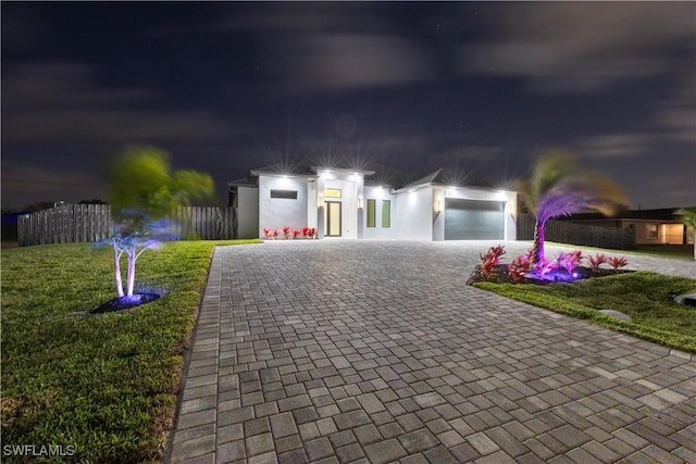 611 NW 25th Ter, Cape Coral, FL 33993 - view of front of property featuring decorative driveway, an attached garage, and stucco siding