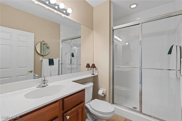 full bath featuring a stall shower, vanity, and toilet