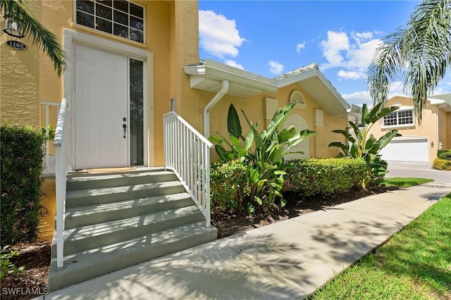 entrance to property with stucco siding