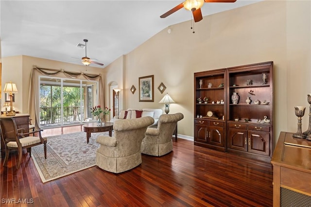 living area with vaulted ceiling, dark wood-type flooring, visible vents, and a ceiling fan