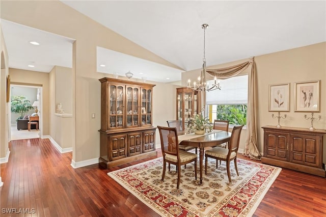 dining room featuring lofted ceiling, dark wood finished floors, and baseboards