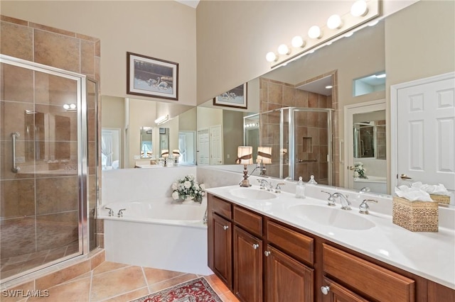 full bath with tile patterned flooring, a shower stall, a garden tub, and a sink