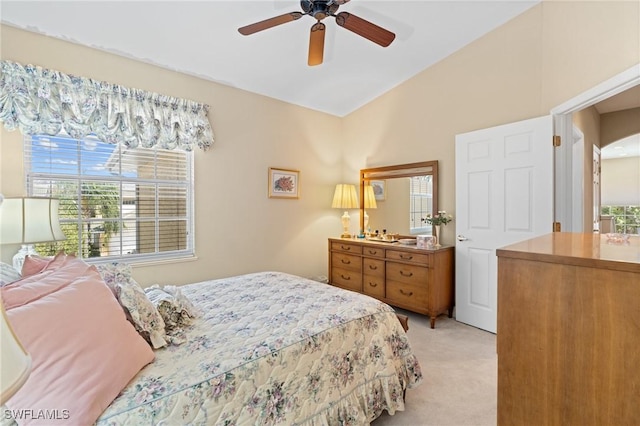 bedroom featuring light carpet, ceiling fan, and vaulted ceiling