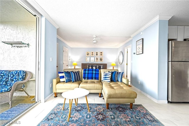 living room featuring ornamental molding, ceiling fan, a textured ceiling, and baseboards