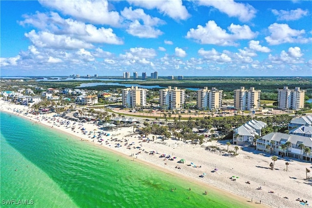 birds eye view of property featuring a view of city, a beach view, and a water view