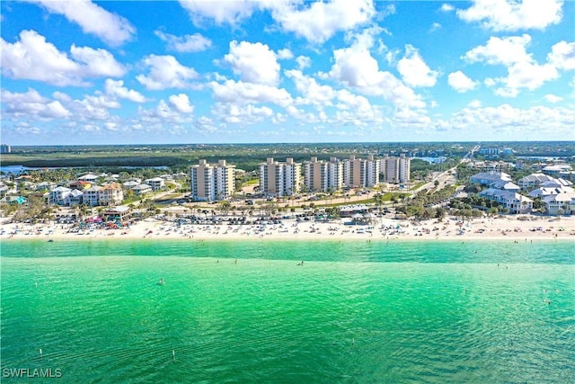 bird's eye view with a water view, a view of city, and a view of the beach