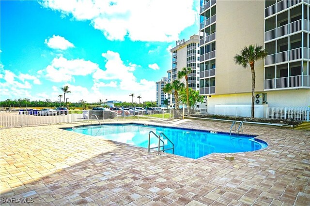 pool with fence and a patio