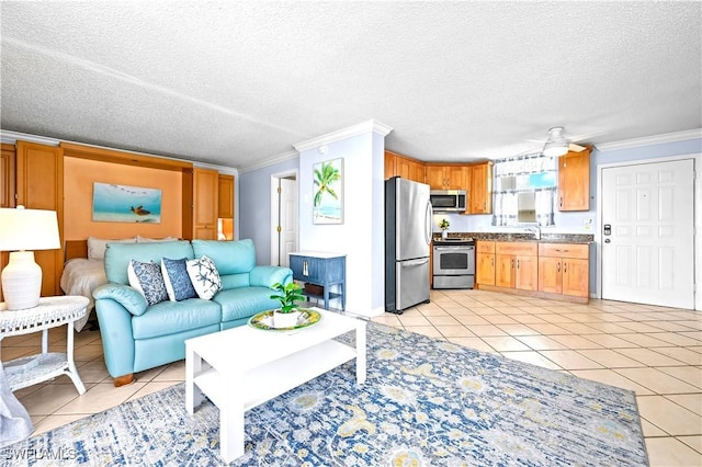 living area featuring ornamental molding, a textured ceiling, and light tile patterned floors