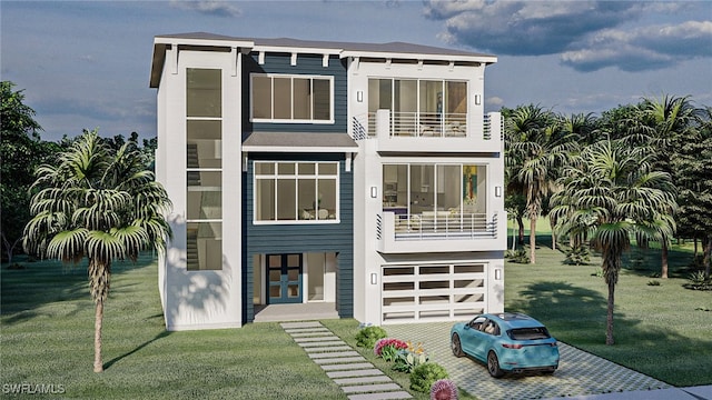 view of front of home featuring a balcony, driveway, and a front lawn