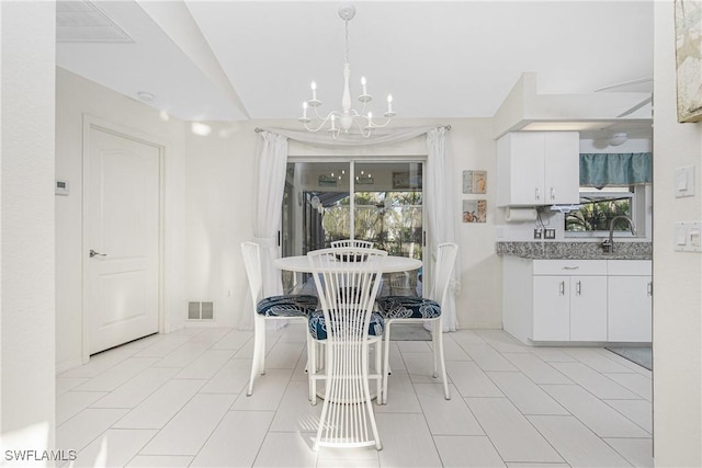 dining room featuring a wealth of natural light, visible vents, and a notable chandelier