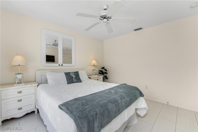 bedroom with ceiling fan, light tile patterned flooring, visible vents, and baseboards