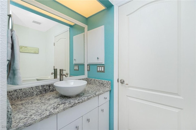 bathroom with vanity and visible vents