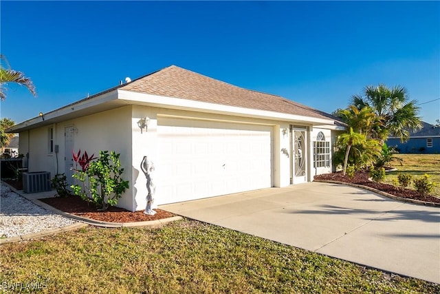 view of home's exterior with a garage, central AC unit, concrete driveway, roof with shingles, and stucco siding