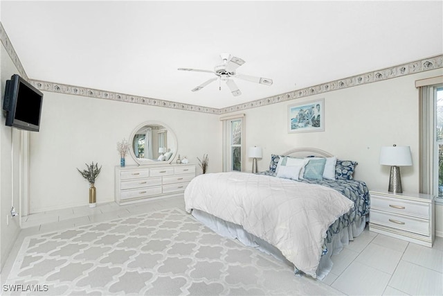 bedroom featuring tile patterned flooring and a ceiling fan