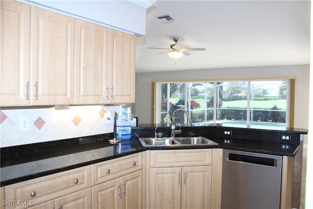 kitchen with visible vents, backsplash, stainless steel dishwasher, light brown cabinetry, and a sink