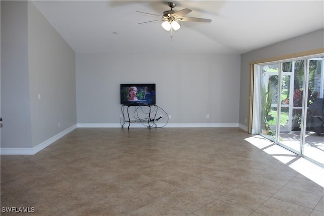 unfurnished living room with ceiling fan and baseboards