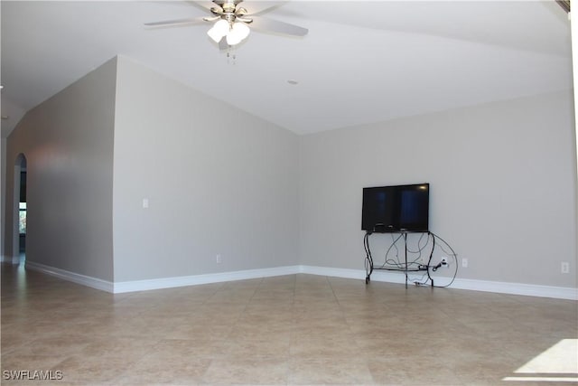 unfurnished living room with arched walkways, ceiling fan, vaulted ceiling, and baseboards