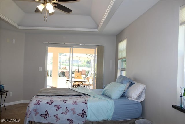 bedroom featuring ceiling fan, tile patterned flooring, baseboards, and a raised ceiling