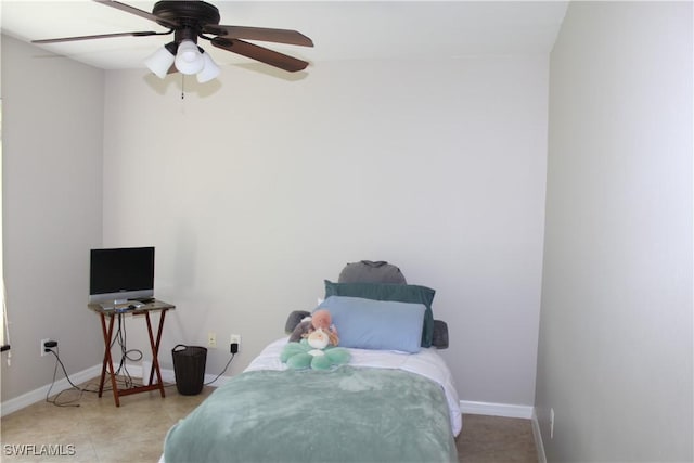 tiled bedroom with baseboards and a ceiling fan