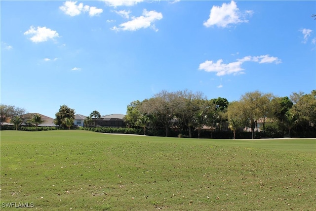 view of home's community featuring a yard and golf course view