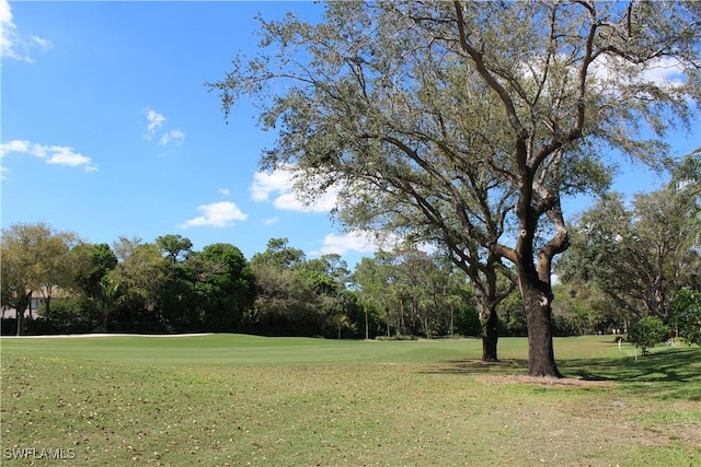 view of property's community featuring a lawn and golf course view