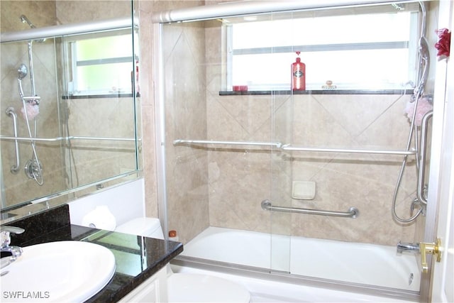 bathroom featuring shower / bath combination with glass door, vanity, and toilet