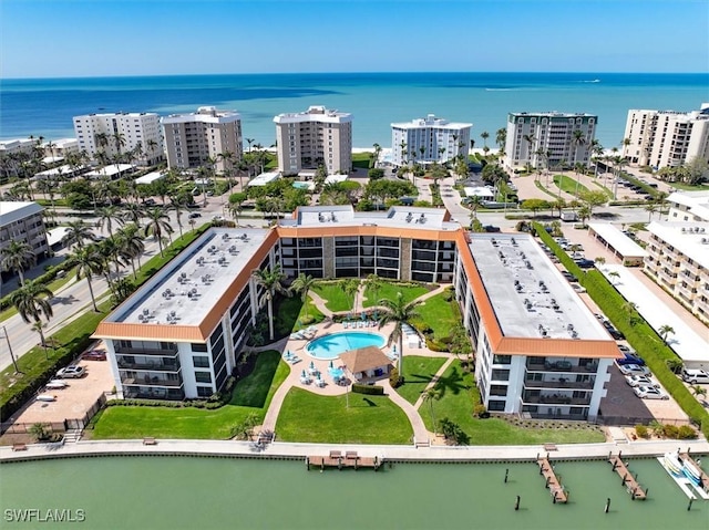 birds eye view of property with a water view and a city view