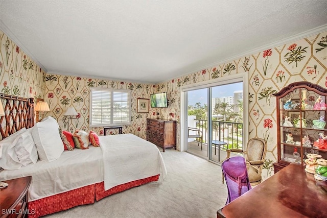 carpeted bedroom with wallpapered walls, multiple windows, access to exterior, and a textured ceiling