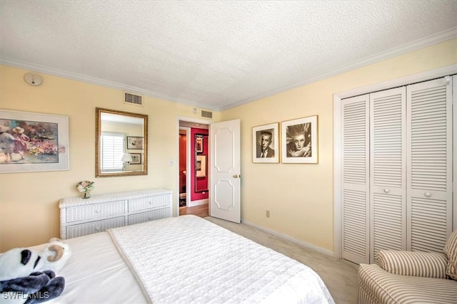 bedroom featuring a textured ceiling, visible vents, a closet, and light colored carpet