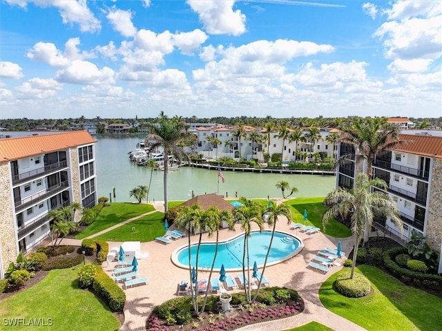 pool featuring a water view, a residential view, and a patio