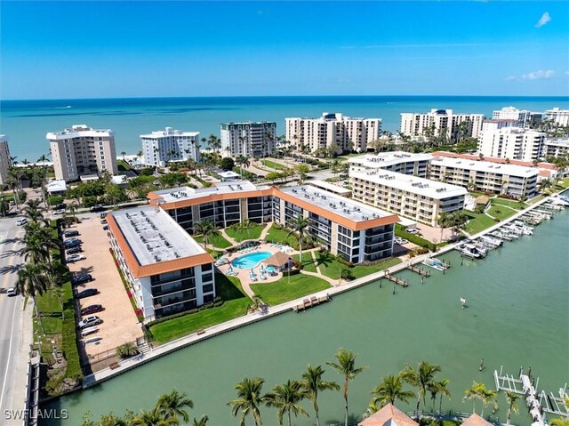 birds eye view of property with a water view and a city view