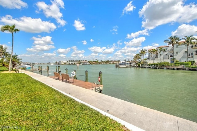 view of dock featuring a yard and a water view