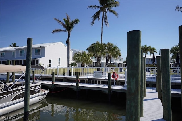 view of dock featuring a water view and fence