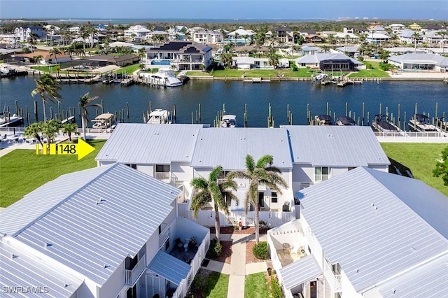 bird's eye view featuring a water view and a residential view