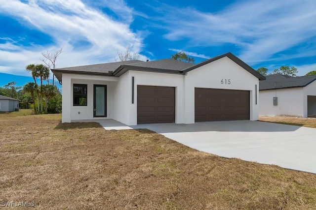 view of front of property with an attached garage, a shingled roof, driveway, stucco siding, and a front yard