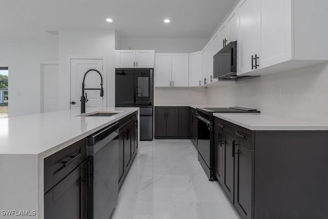 kitchen featuring black appliances, a sink, light countertops, and white cabinets