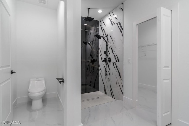 bathroom featuring marble finish floor, toilet, a spacious closet, and a marble finish shower