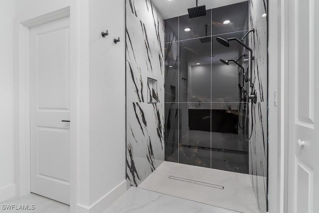 bathroom with a marble finish shower