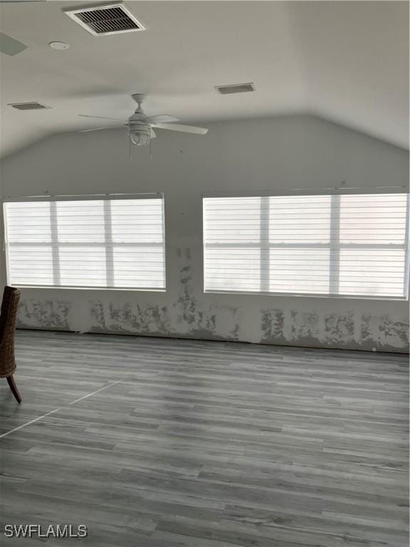 unfurnished room with visible vents and vaulted ceiling