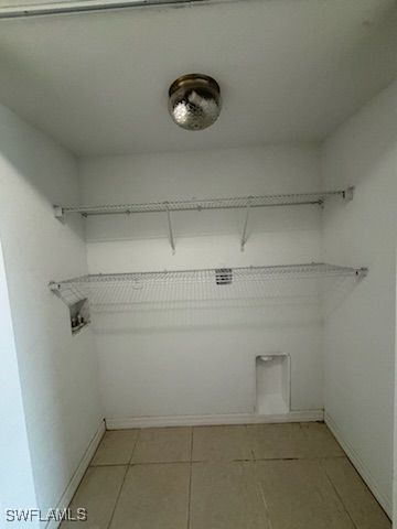 3510 5th St SW, Lehigh Acres, FL 33976 - washroom featuring baseboards, laundry area, light tile patterned floors, and hookup for an electric dryer