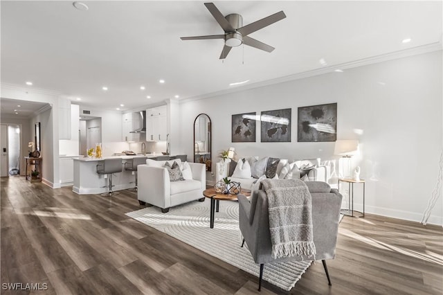 living area featuring recessed lighting, crown molding, baseboards, and wood finished floors