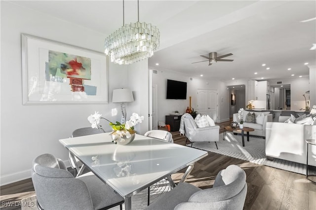 dining space featuring baseboards, ceiling fan with notable chandelier, wood finished floors, and recessed lighting