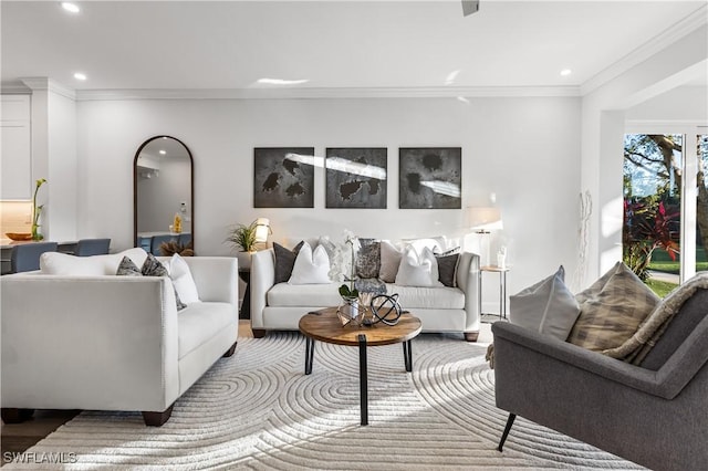 living area with ornamental molding and recessed lighting