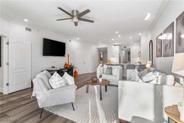 living area with dark wood-style floors, ceiling fan, crown molding, and recessed lighting