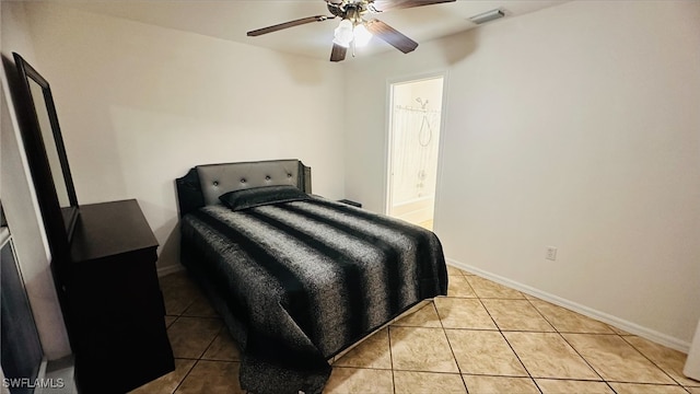 tiled bedroom with connected bathroom, baseboards, visible vents, and ceiling fan