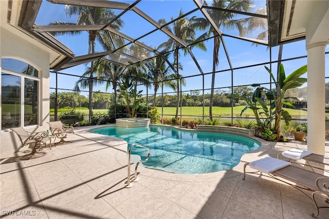 view of swimming pool featuring glass enclosure, a patio area, and a pool with connected hot tub